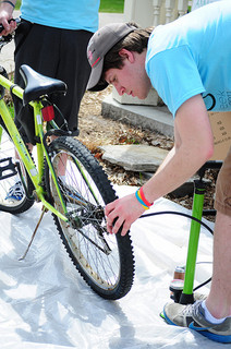 A student helps pump a tire at WSU's Bike Week. 